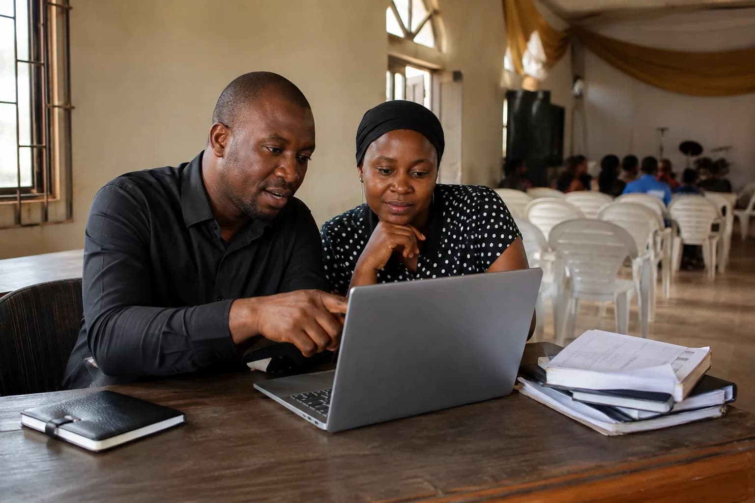 Church volunteers coordinating a community event on a laptop