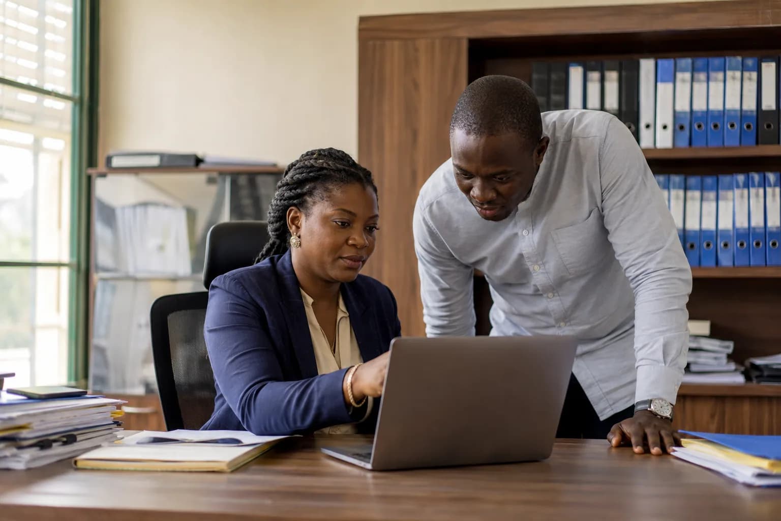 Admissions staff reviewing a student workflow on a laptop