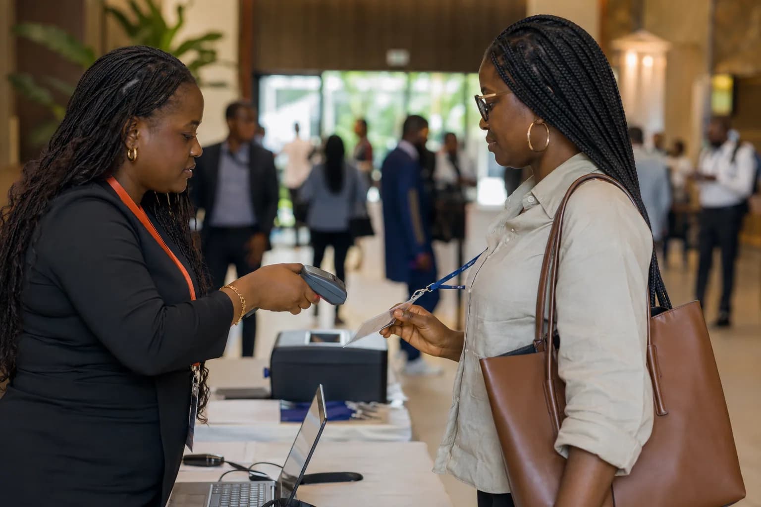An event coordinator scanning an attendee badge at conference check-in