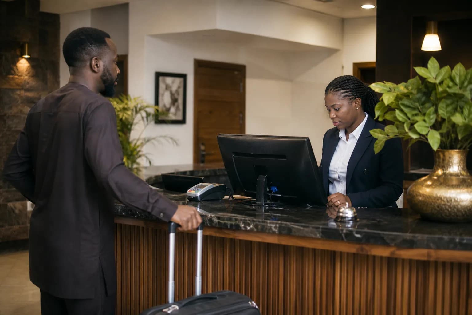 A hotel receptionist managing a guest booking