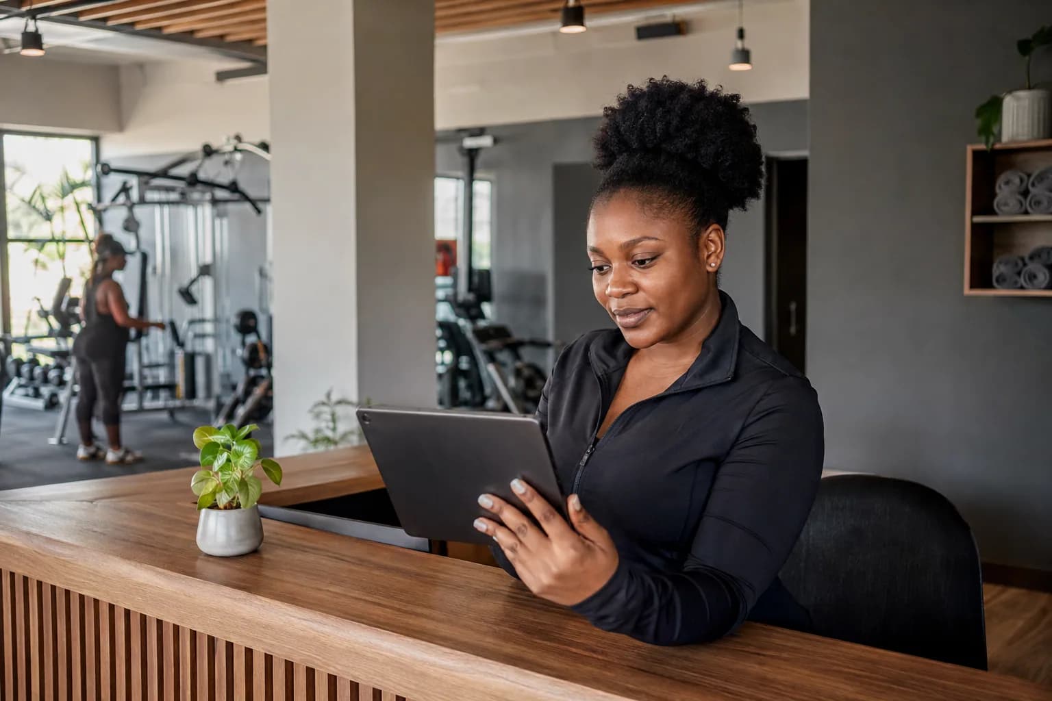 A fitness studio manager reviewing class bookings