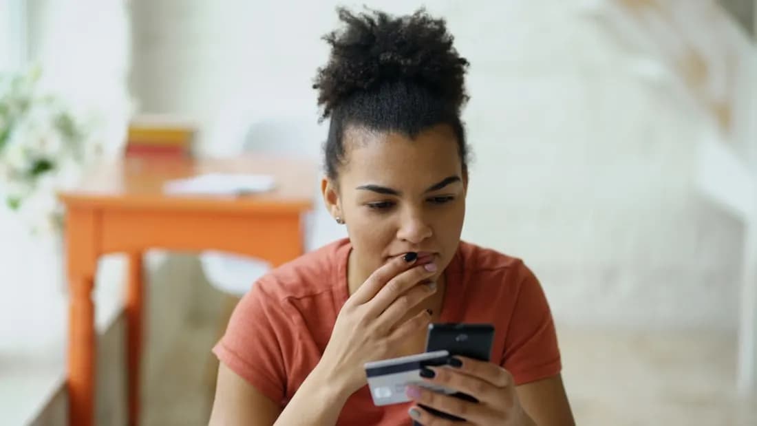 A shopper comparing products and paying by card on an online store